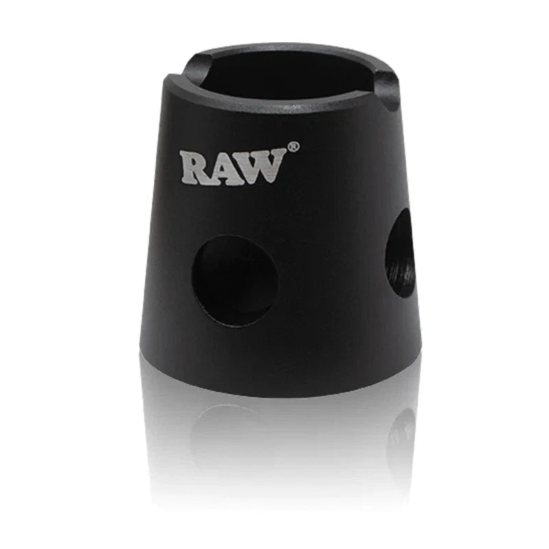 Raw magnetic metal cigarette snuffer attached to a metal ashtray, designed for safely extinguishing and storing cigarette butts.